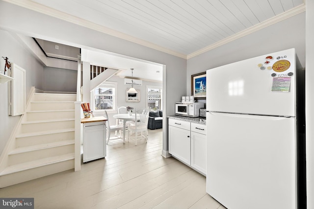 kitchen featuring ornamental molding, an AC wall unit, light wood-type flooring, white cabinets, and white appliances