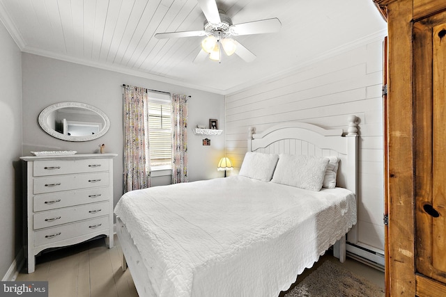 bedroom featuring ceiling fan, crown molding, and baseboard heating