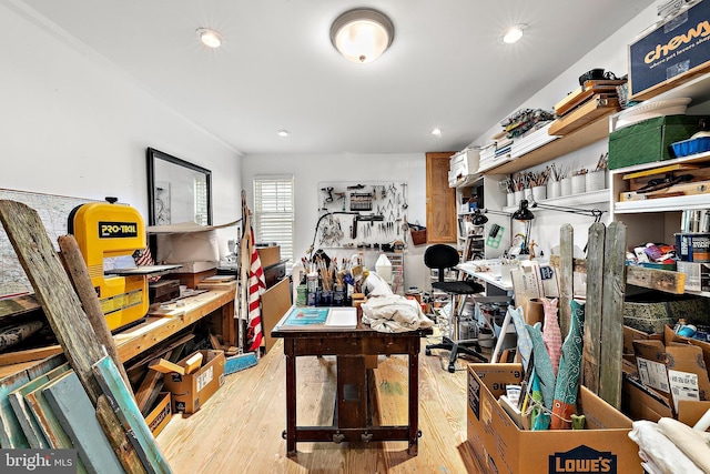 office featuring light hardwood / wood-style flooring and a workshop area