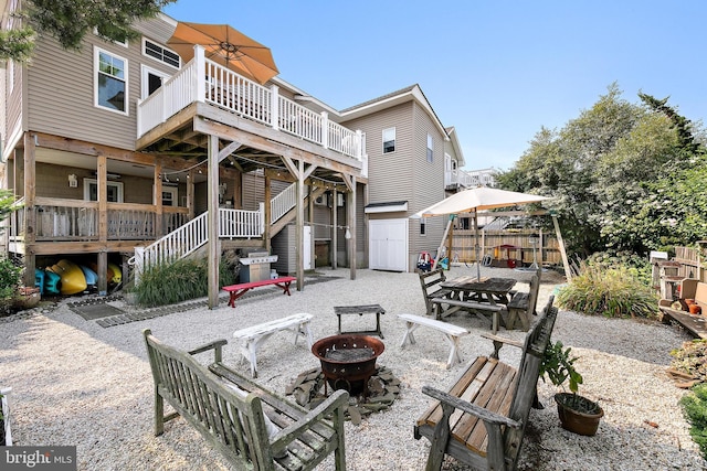 back of property with a patio and a fire pit