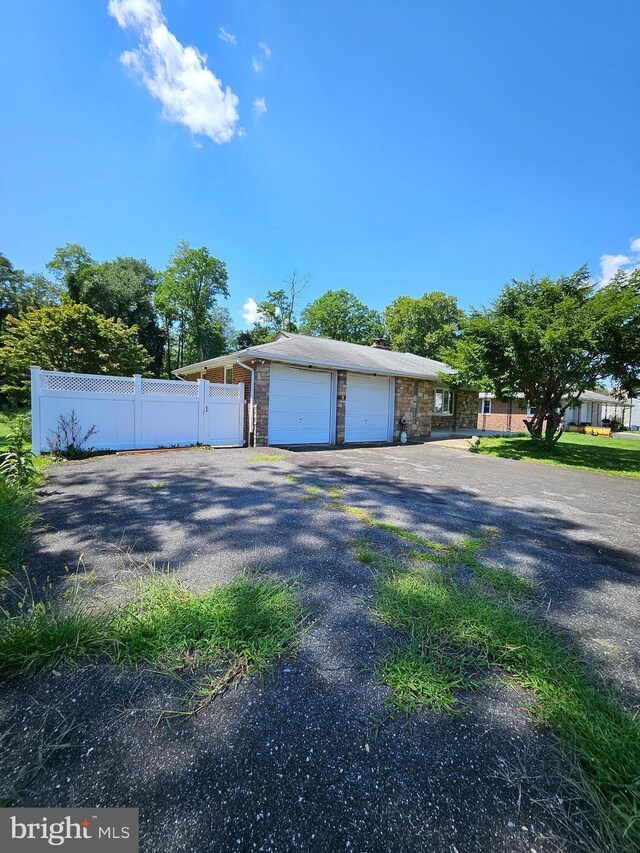 view of front of home with a garage and an outbuilding