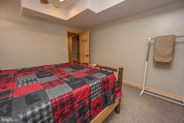 bedroom featuring carpet and baseboards