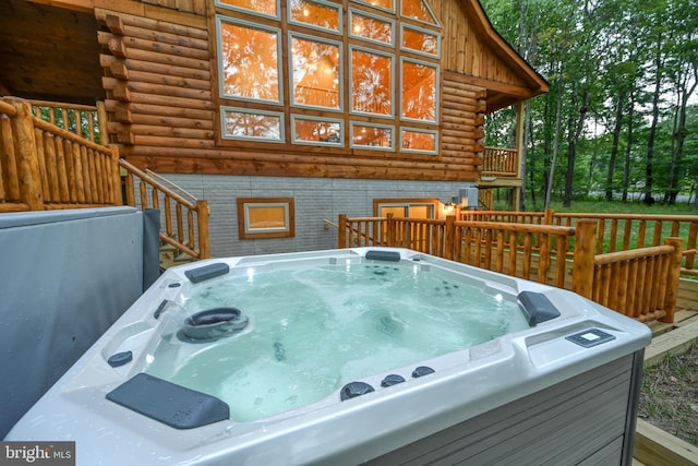 wooden terrace with a hot tub