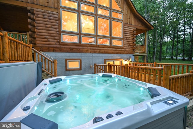 wooden deck with a hot tub