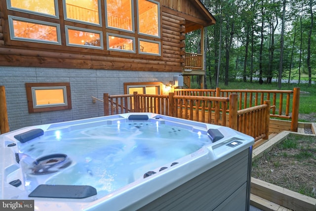 wooden terrace featuring a hot tub