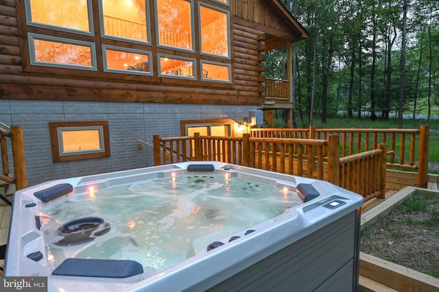 wooden deck with a hot tub