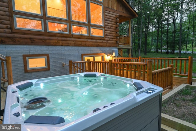 wooden terrace featuring a hot tub