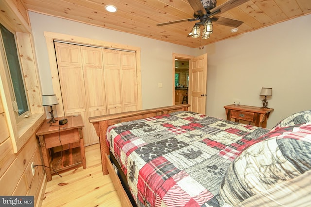 bedroom with wooden ceiling, ceiling fan, light wood finished floors, and a closet