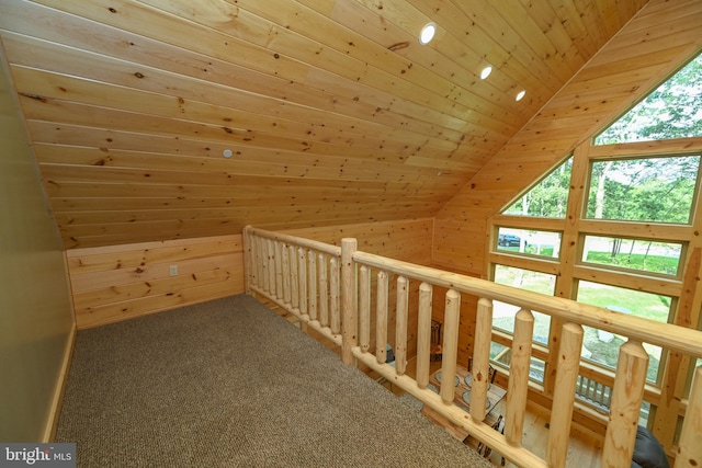 additional living space featuring vaulted ceiling, carpet flooring, wood ceiling, and wooden walls