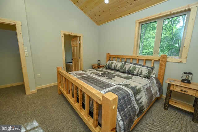 bedroom featuring vaulted ceiling, dark colored carpet, wood ceiling, and baseboards