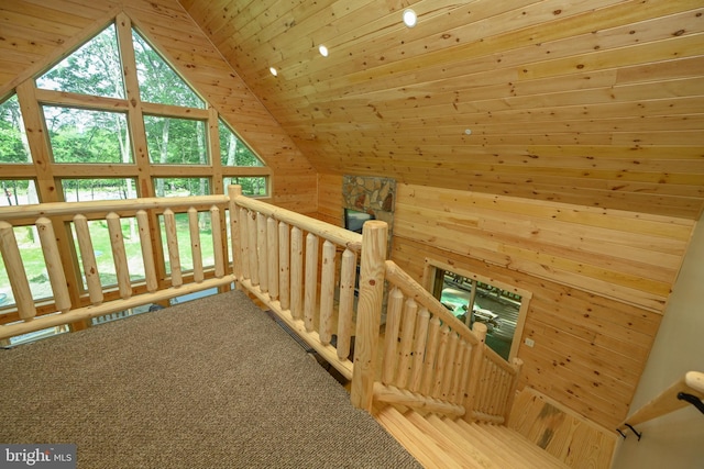 bonus room featuring carpet floors, lofted ceiling, wood ceiling, and wood walls