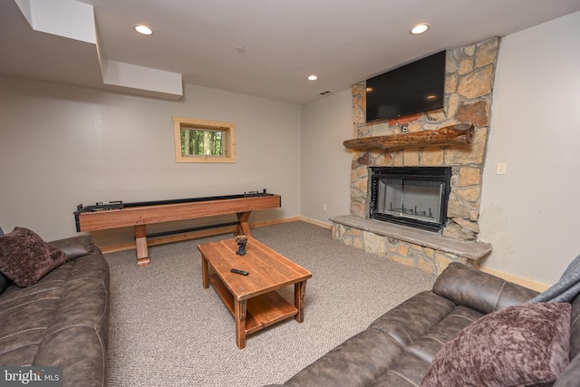 carpeted living area featuring recessed lighting, visible vents, a stone fireplace, and baseboards