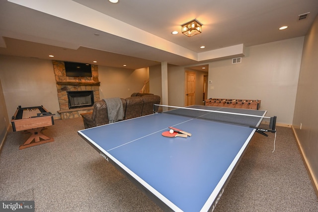 playroom with a stone fireplace, recessed lighting, visible vents, baseboards, and dark colored carpet