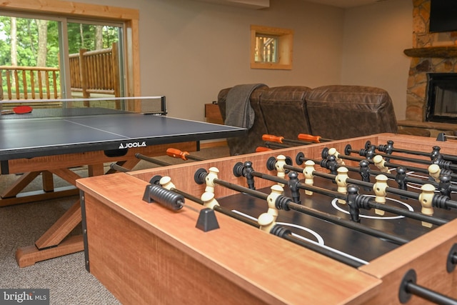 recreation room with carpet flooring and a fireplace