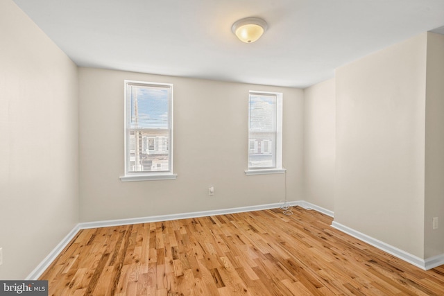 empty room featuring light wood-type flooring and a wealth of natural light