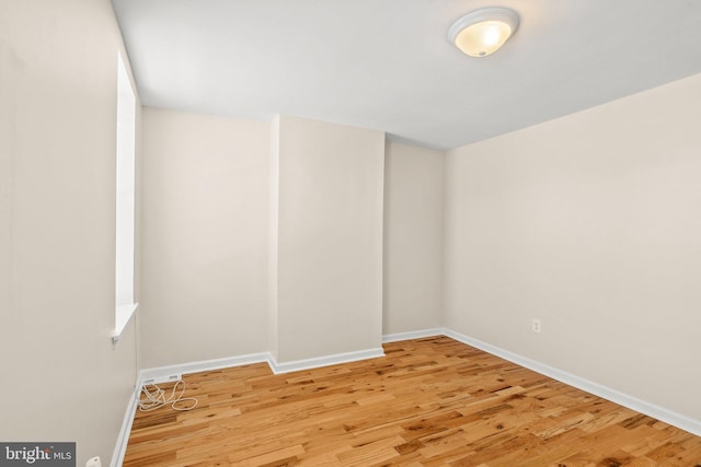 empty room with light hardwood / wood-style flooring