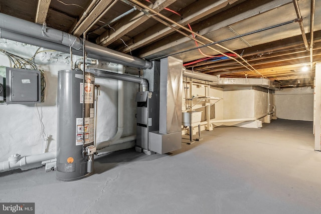 basement featuring water heater and electric panel