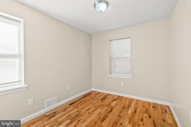 unfurnished room with light hardwood / wood-style flooring