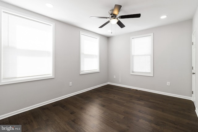 unfurnished room with a wealth of natural light, ceiling fan, and hardwood / wood-style flooring