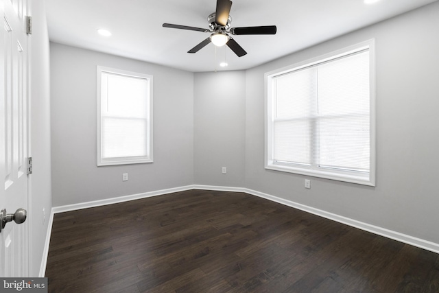 unfurnished room featuring a wealth of natural light, ceiling fan, and hardwood / wood-style flooring