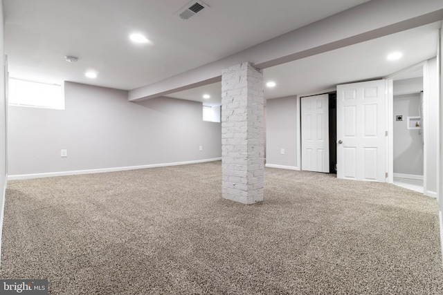 basement with brick wall and carpet