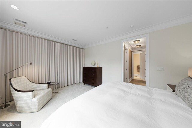 carpeted bedroom featuring crown molding