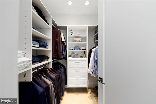 walk in closet featuring carpet