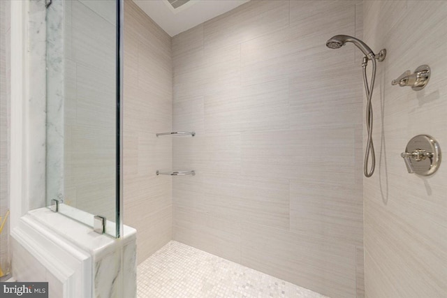 bathroom with tiled shower