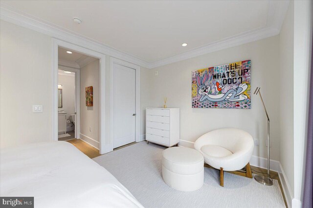 bedroom with hardwood / wood-style floors and ornamental molding