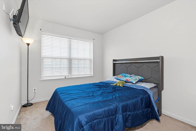 bedroom featuring light carpet