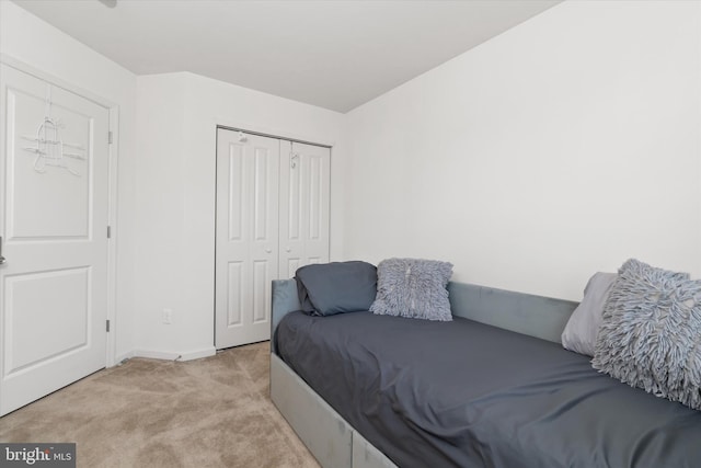 carpeted bedroom with a closet