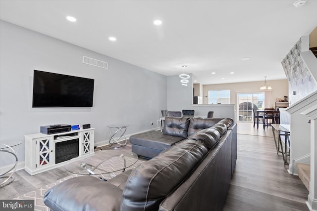 living room featuring light hardwood / wood-style flooring and a chandelier