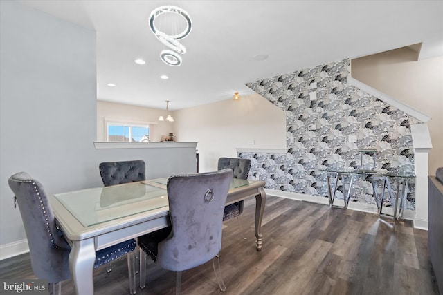 dining room with dark wood-type flooring and a notable chandelier