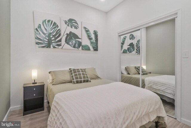 bedroom featuring light hardwood / wood-style floors and a closet