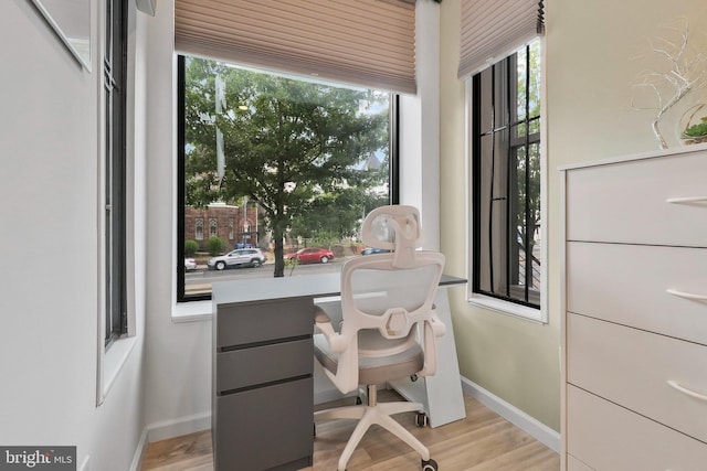 office with light hardwood / wood-style flooring