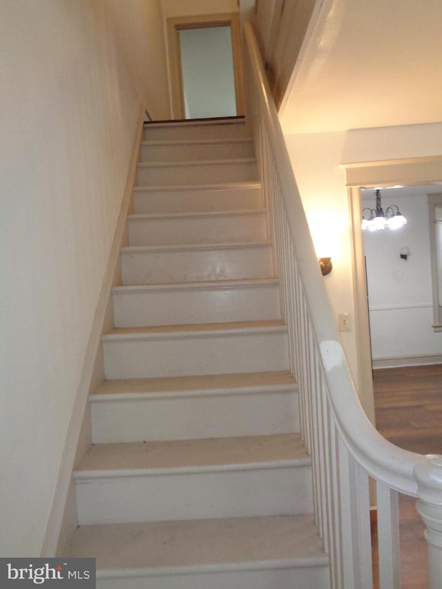 stairway featuring hardwood / wood-style flooring