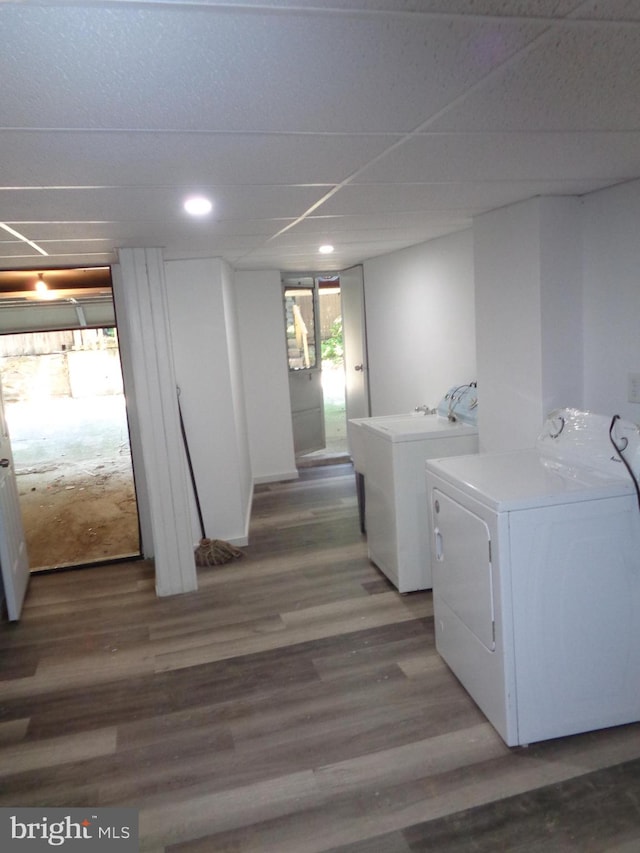 clothes washing area with washing machine and dryer and wood-type flooring