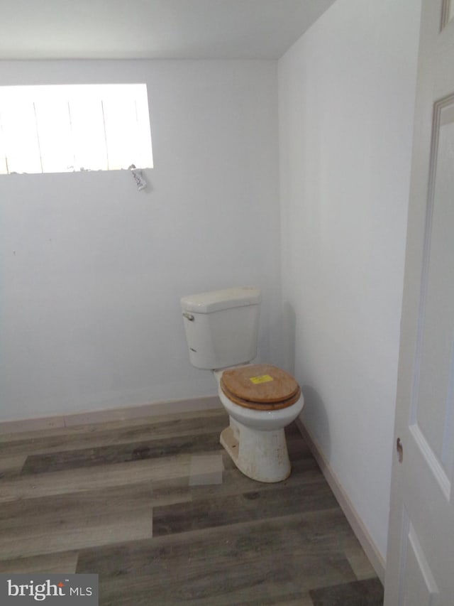 bathroom featuring hardwood / wood-style floors and toilet