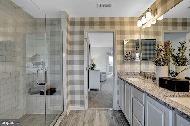 bathroom featuring vanity, hardwood / wood-style flooring, and walk in shower