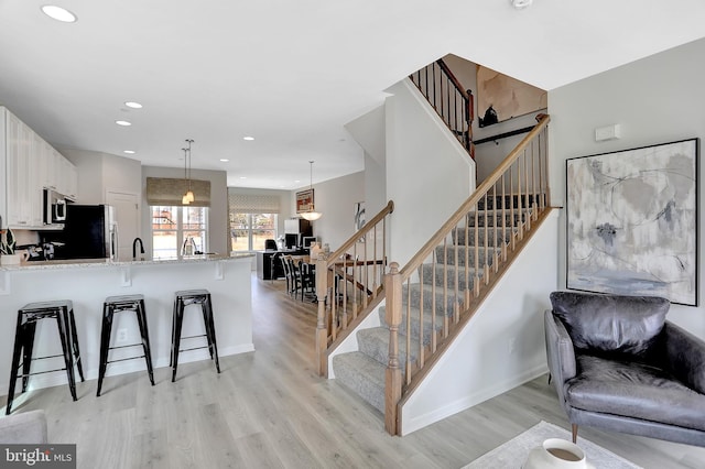 interior space with sink and hardwood / wood-style floors