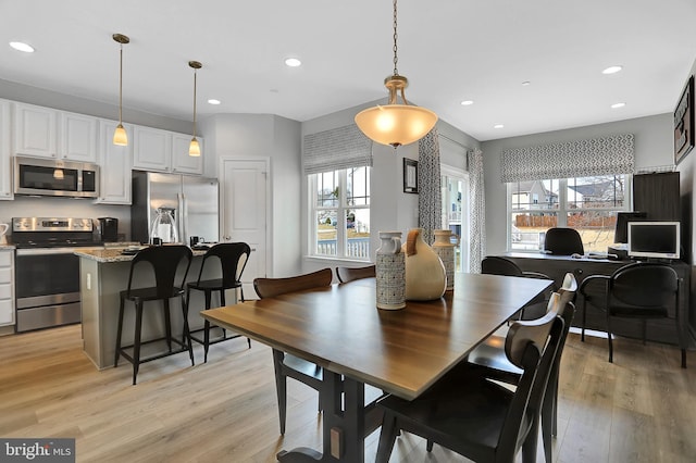 dining space featuring a wealth of natural light and light hardwood / wood-style flooring