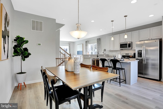 dining area with light hardwood / wood-style floors