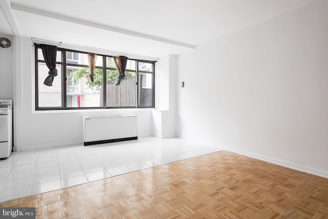 unfurnished room with light parquet flooring