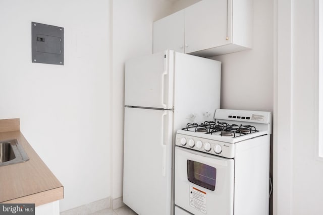 kitchen featuring white cabinetry, electric panel, and white gas stove