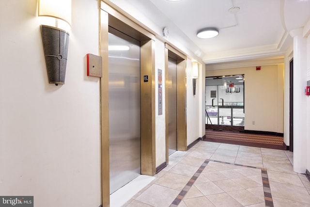 corridor with elevator and light tile patterned floors