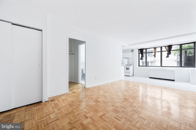 unfurnished living room featuring light parquet flooring