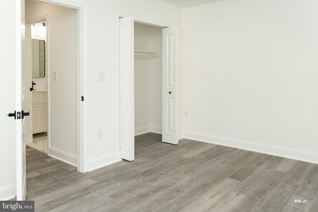 unfurnished bedroom with a closet and light hardwood / wood-style flooring