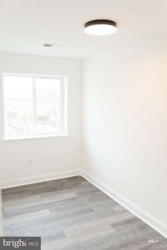 spare room with hardwood / wood-style floors