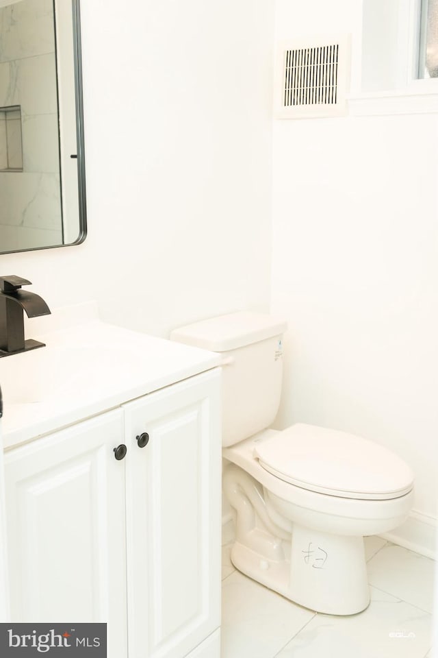 bathroom with a shower, vanity, and toilet