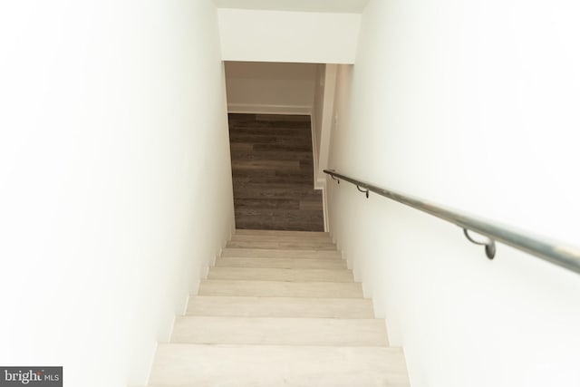 staircase with hardwood / wood-style floors